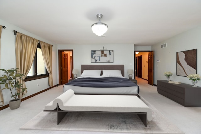 bedroom with visible vents, baseboards, and light carpet