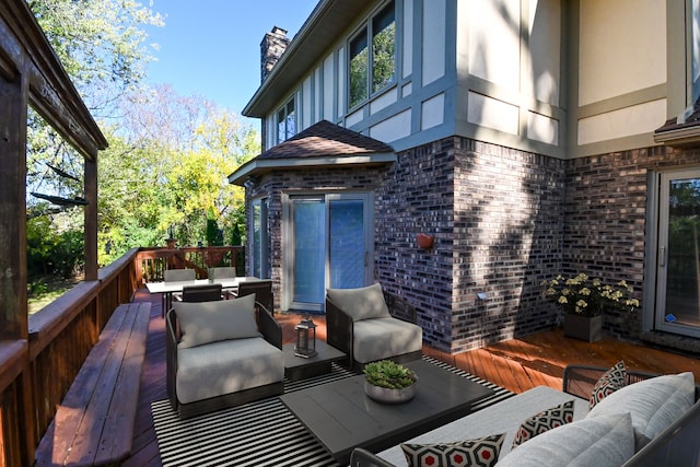 deck with outdoor dining space and an outdoor living space