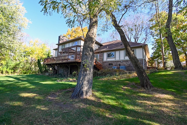 back of house featuring a yard and a deck