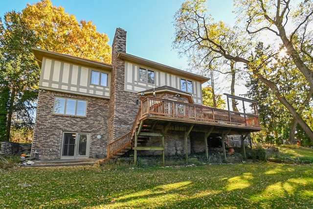 back of house featuring a deck and a lawn