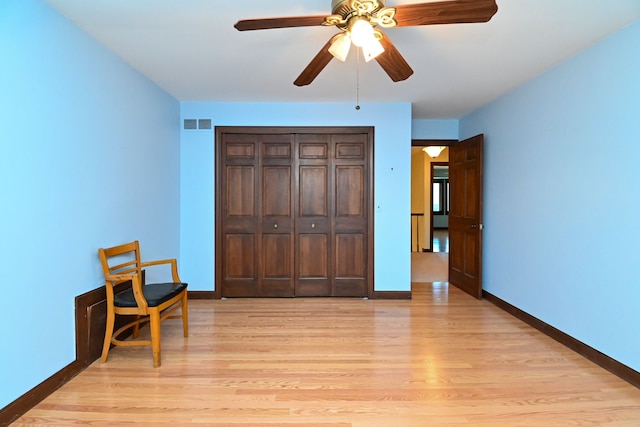 bedroom with light hardwood / wood-style flooring, a closet, and ceiling fan