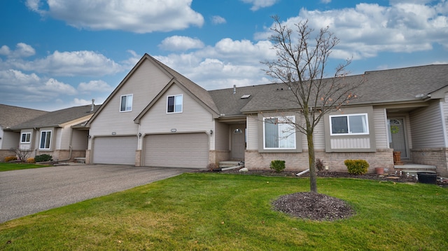 view of front of house featuring a front yard and a garage