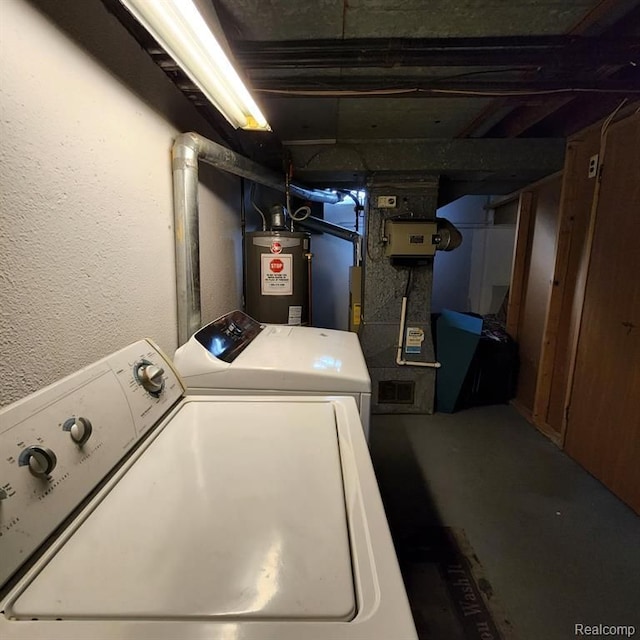 clothes washing area with washer and clothes dryer and gas water heater