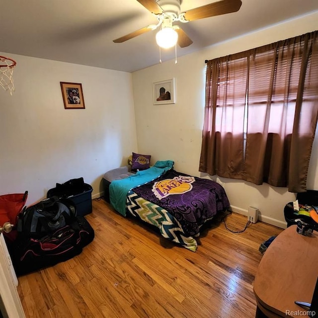 bedroom with ceiling fan and light wood-type flooring