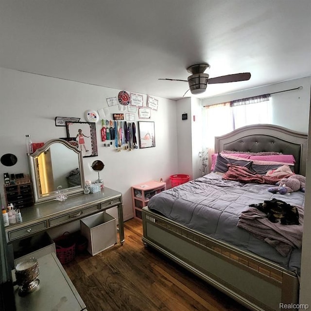 bedroom with ceiling fan and dark hardwood / wood-style floors