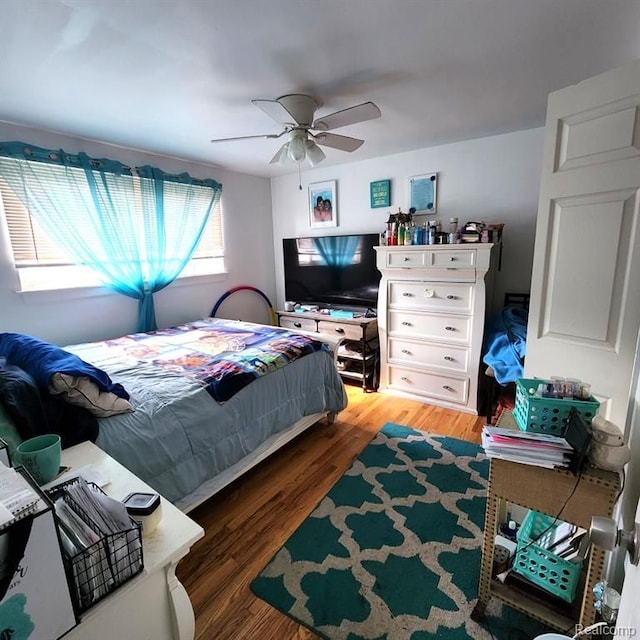 bedroom with wood-type flooring and ceiling fan