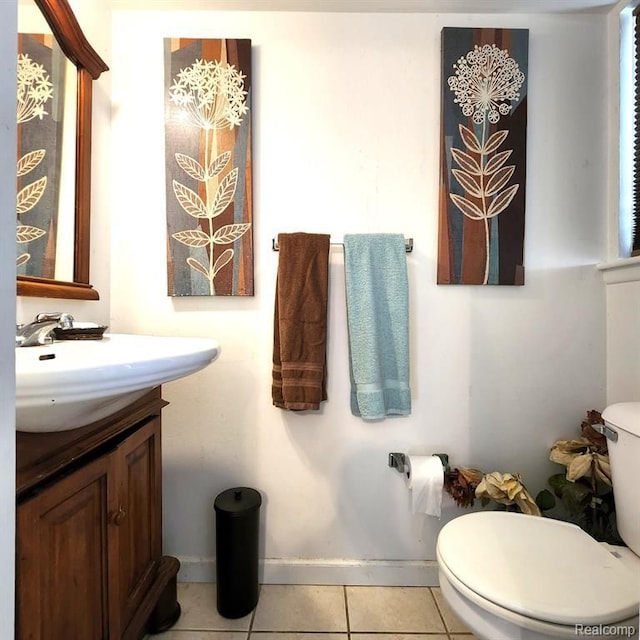 bathroom with tile patterned flooring, vanity, and toilet