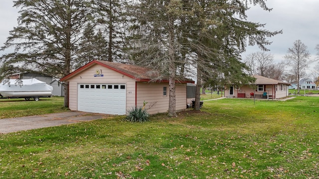 view of property exterior featuring a yard, an outbuilding, and a garage