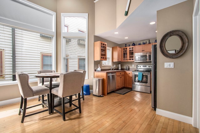 kitchen featuring a wealth of natural light, light wood-type flooring, sink, and appliances with stainless steel finishes