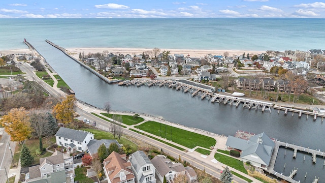 drone / aerial view with a beach view and a water view