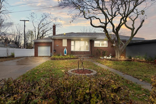 ranch-style house with a garage and a yard