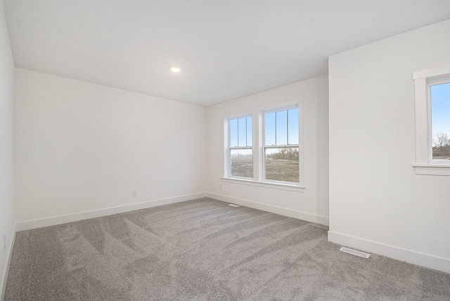 unfurnished room featuring light carpet, recessed lighting, visible vents, and baseboards
