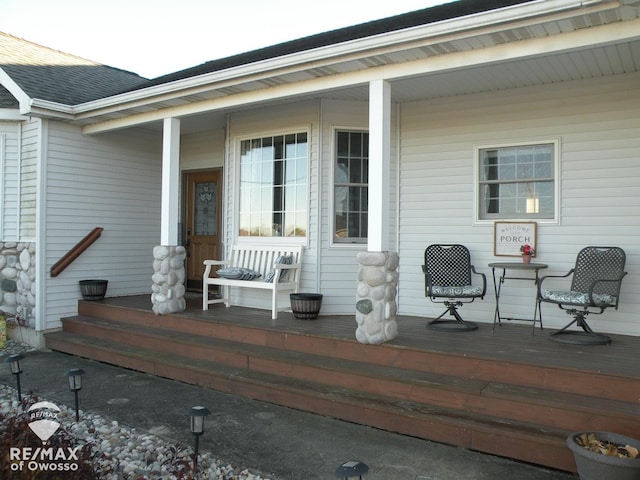 wooden terrace featuring covered porch