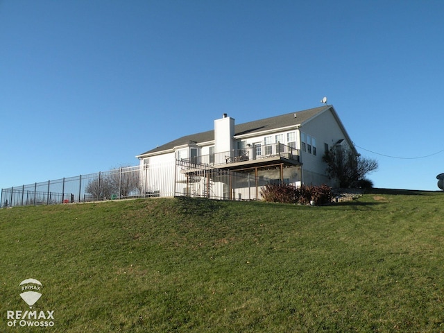 back of house with a lawn