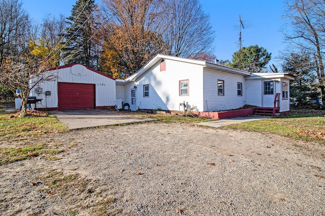 view of front facade featuring an outbuilding and a garage