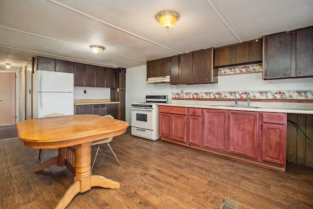 kitchen featuring dark hardwood / wood-style flooring, sink, and white appliances