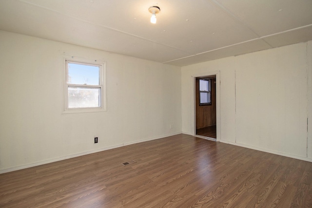 empty room featuring dark hardwood / wood-style flooring