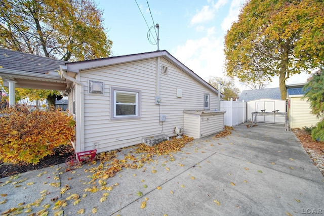 rear view of property featuring a shed