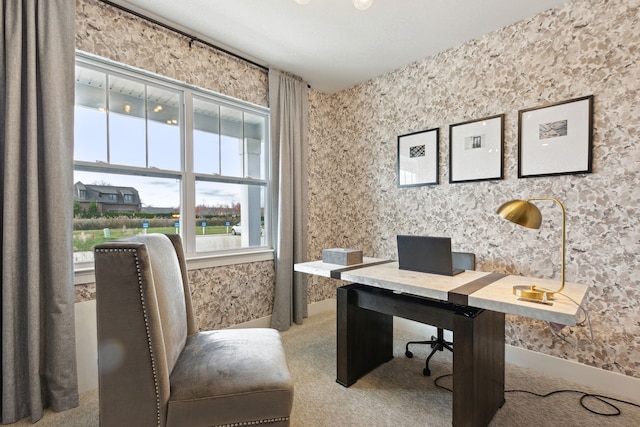 carpeted home office featuring wallpapered walls