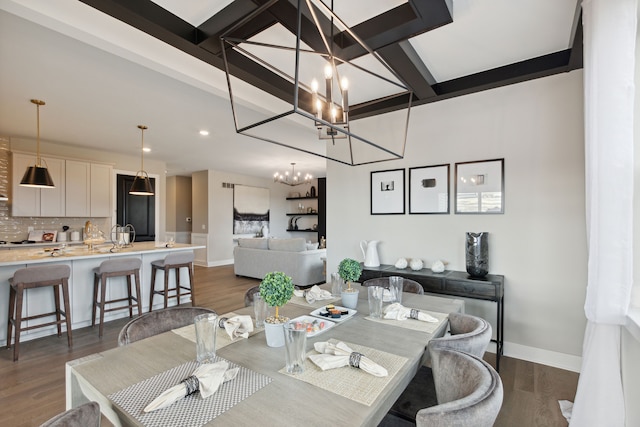 dining space featuring beam ceiling, a notable chandelier, dark wood-style floors, and baseboards