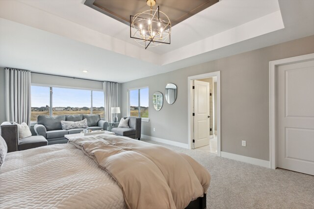 bedroom with a raised ceiling, light colored carpet, and an inviting chandelier