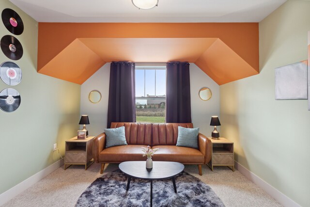 sitting room with carpet floors and lofted ceiling