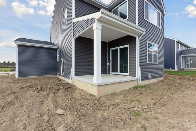 rear view of property featuring a patio area