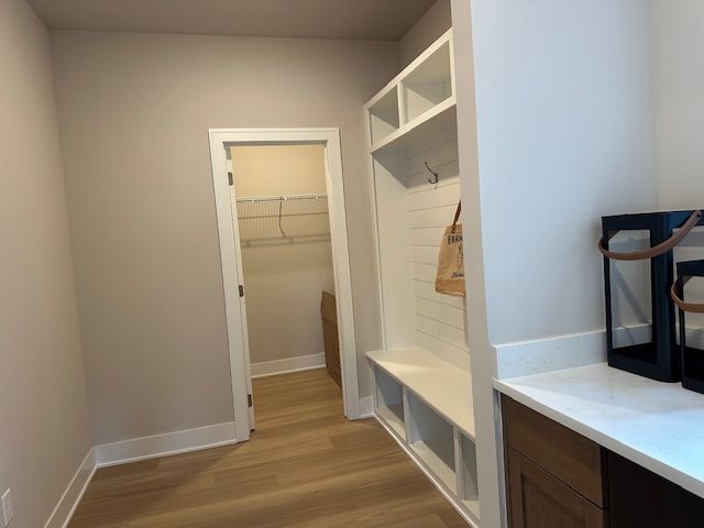 mudroom with light wood-type flooring and baseboards