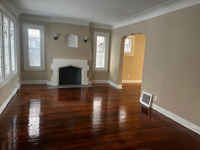 unfurnished living room with dark hardwood / wood-style floors and a textured ceiling