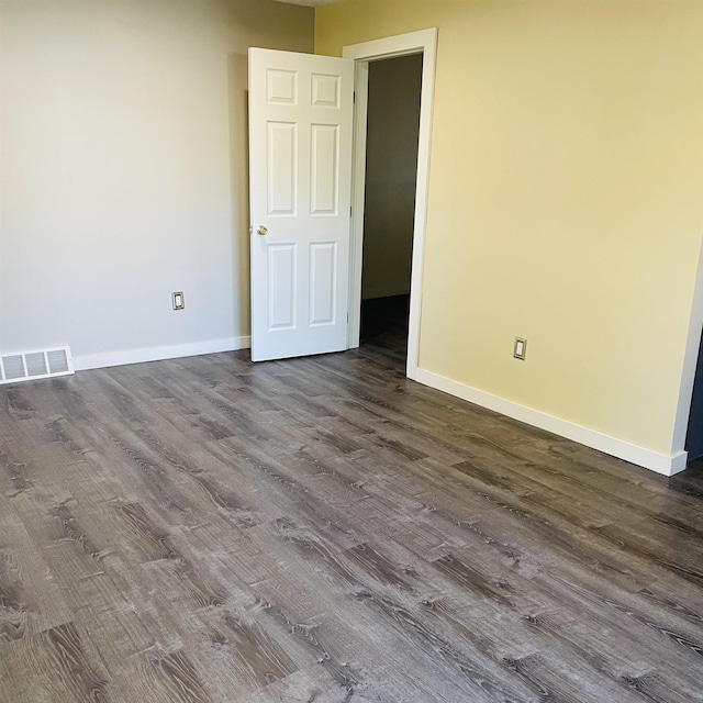 spare room with dark hardwood / wood-style flooring