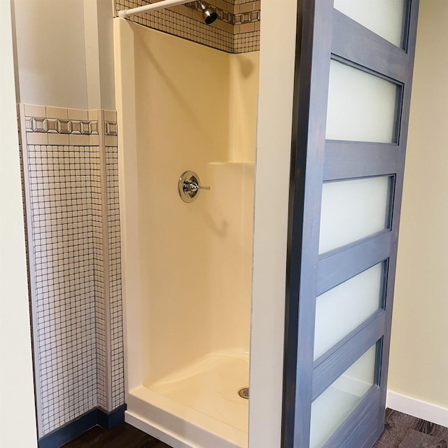 bathroom with wood-type flooring and a shower