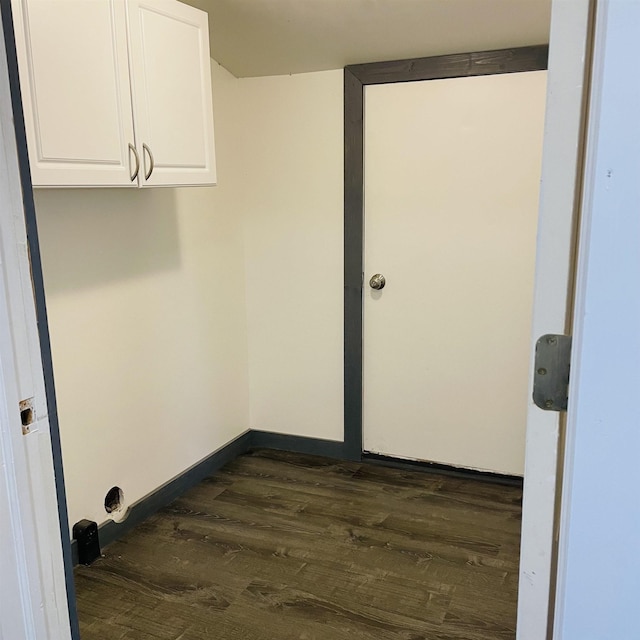 laundry room with cabinets and dark wood-type flooring