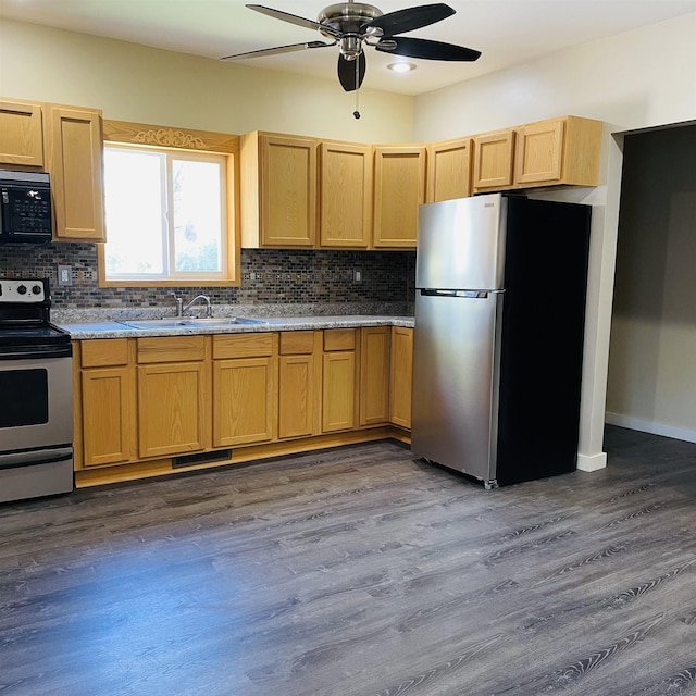 kitchen featuring sink, backsplash, stainless steel appliances, and hardwood / wood-style flooring