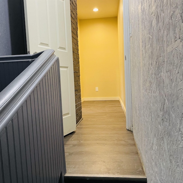 corridor with light hardwood / wood-style floors