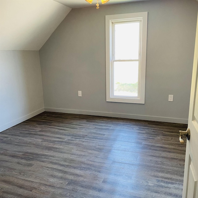 bonus room with vaulted ceiling and dark wood-type flooring