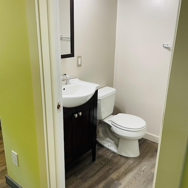 bathroom with vanity, hardwood / wood-style floors, and toilet