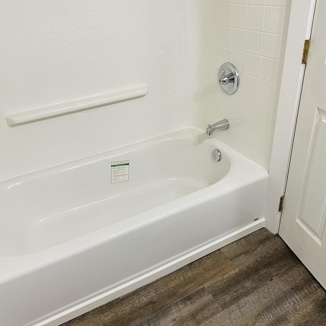 bathroom with shower / bathtub combination and wood-type flooring