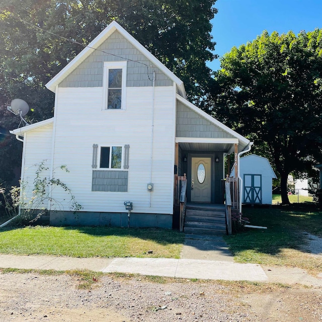 view of front facade featuring a storage unit and a front lawn