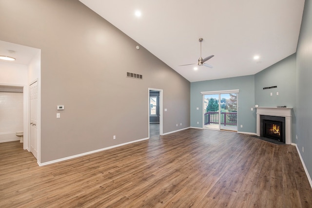 unfurnished living room with hardwood / wood-style floors, ceiling fan, and high vaulted ceiling