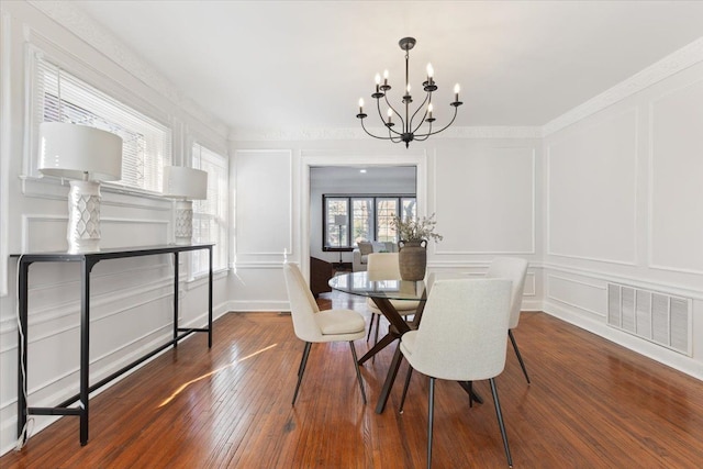 dining area featuring hardwood / wood-style floors and a chandelier