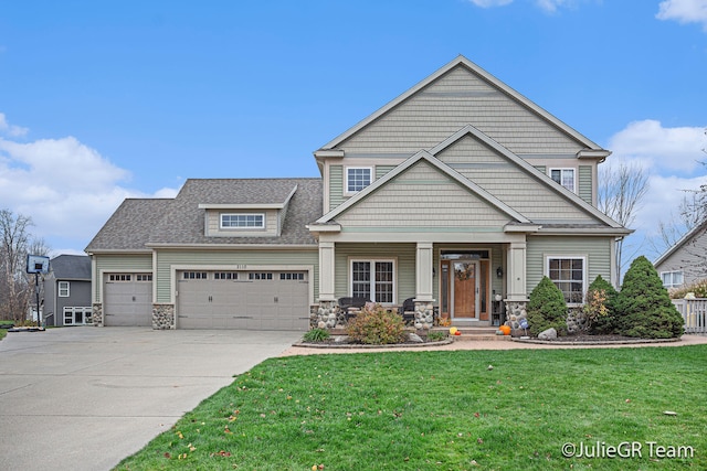 craftsman-style house featuring a garage and a front lawn