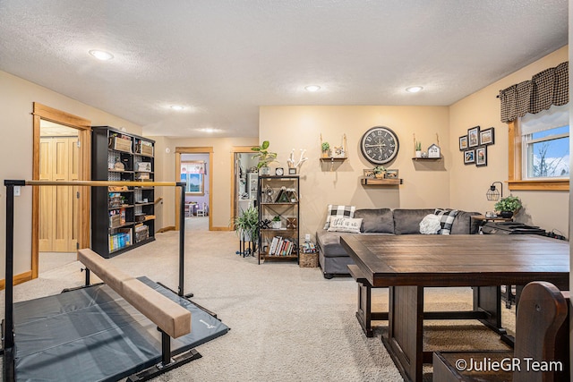 exercise room with carpet flooring and a textured ceiling