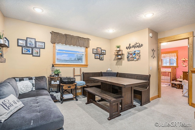 living room featuring light carpet and a textured ceiling