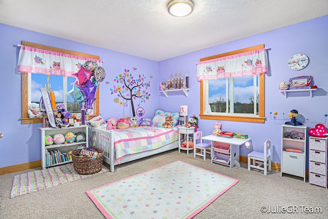 bedroom with carpet floors and a textured ceiling