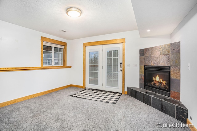 interior space featuring a tile fireplace and a textured ceiling