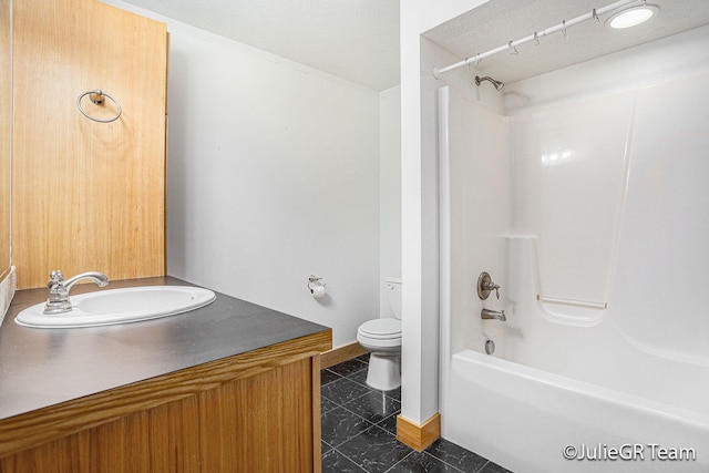 full bathroom with tile patterned flooring, vanity, tub / shower combination, and toilet