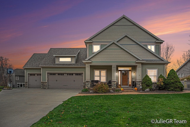 craftsman-style home with a garage and a lawn