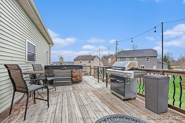 wooden deck featuring a grill and a hot tub