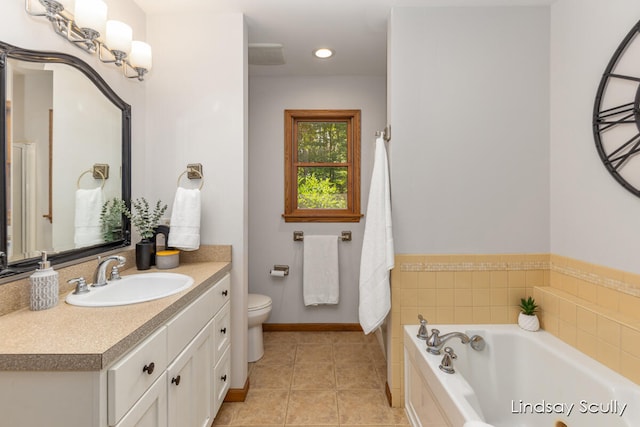 bathroom with tile patterned flooring, vanity, toilet, and a bathtub