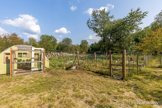 view of yard featuring a rural view and an outbuilding